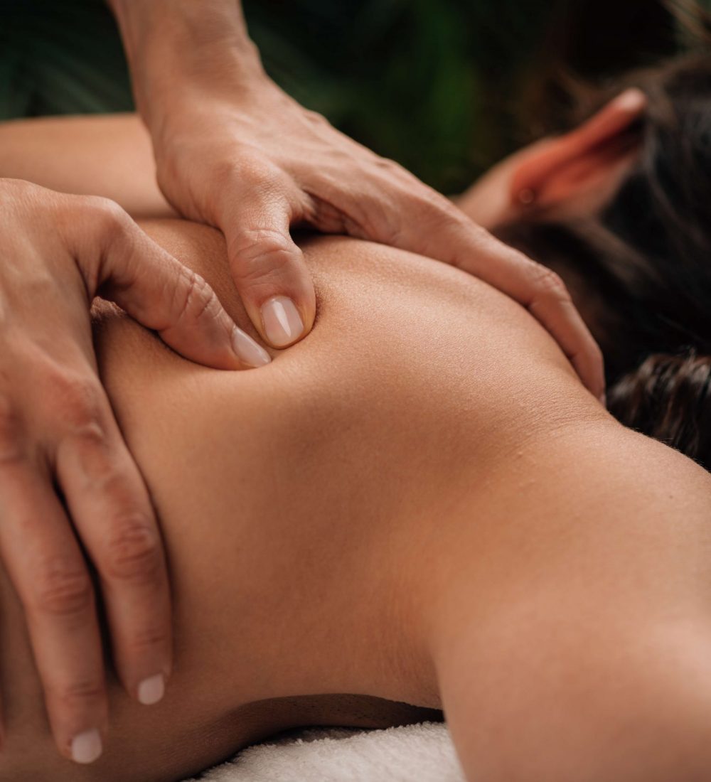 Woman Enjoying Deep Tissue Massage in Salon